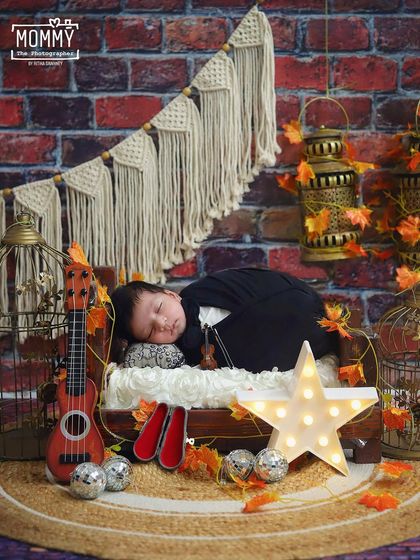 A warm and rustic musical theme for a baby girl. She is sleeping peacefully on a tiny bed with a violin, ukulele, and a glowing star light, creating a cozy and magical mood.