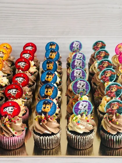 This large order of Paw Patrol themed cupcakes is perfect for a big birthday bash. I've arranged the cupcakes by character, including Chase, Marshall, and Skye, each with a custom paper topper and colorful sprinkles on a swirl of ombré buttercream.