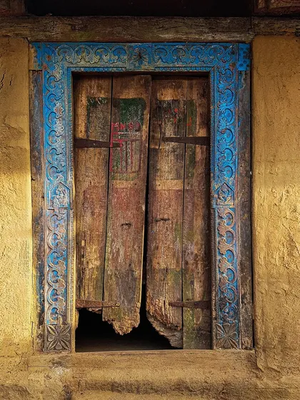 An old, decaying door with a beautifully carved blue frame, discovered in a small village. This image is from my project "The Doors of Maharashtra," where I explore how these structures tell stories of time and history.