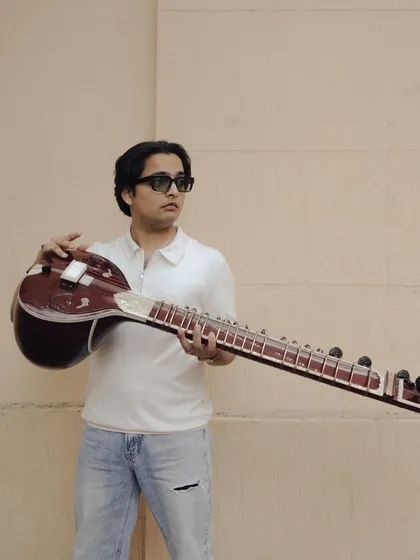 Holding my sitar. This instrument is more than just wood and strings; it is an extension of my voice and soul.