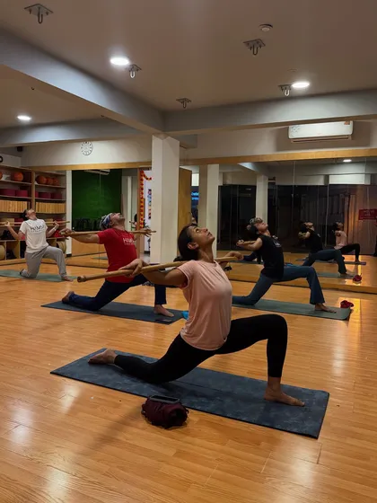 In our stick yoga classes, we use simple props to achieve powerful results. This practice is fantastic for correcting posture, building functional strength, and deepening your connection to each pose.