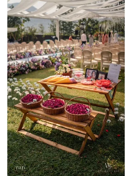 A simple and elegant petal toss station for a garden wedding. We provide guests with baskets of fresh rose petals to shower the couple with blessings as they walk down the aisle.