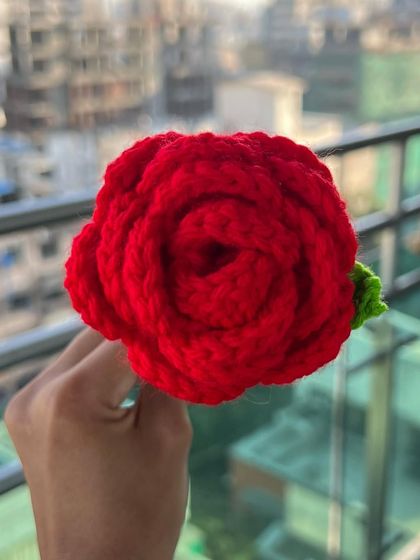 A close-up of a single red crochet rose. I designed this to capture the classic beauty of a real rose, with detailed petals and a vibrant color that will never fade.