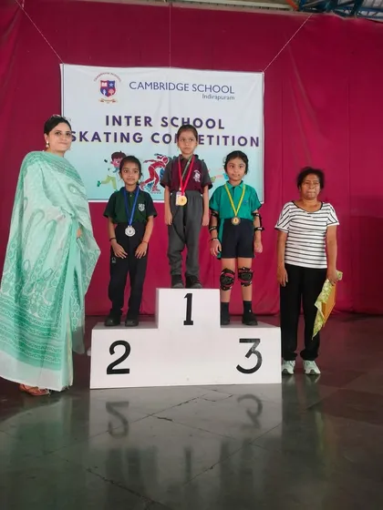 We celebrate every victory, big and small. Here, our talented young skaters stand proudly on the podium after winning medals at an inter-school skating competition, a testament to their hard work and our dedicated coaching.