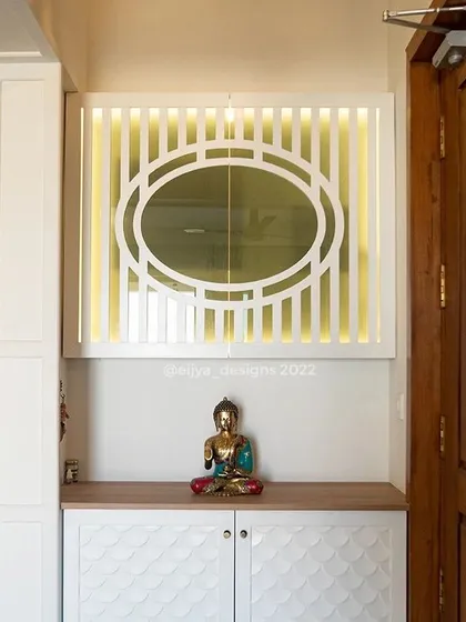 I transformed this entrance into a calming, zen-like space. The design features a shoe cabinet with a unique fish-scale pattern on the shutters and a backlit panel with a geometric design, creating a warm and welcoming first impression.