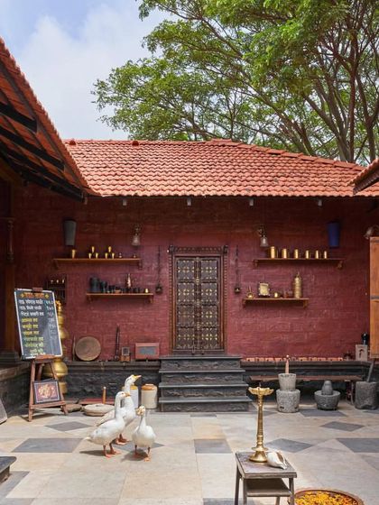 The central courtyard of the restaurant is a lively space, complete with resident geese, a hand-painted blackboard menu, and traditional decor.