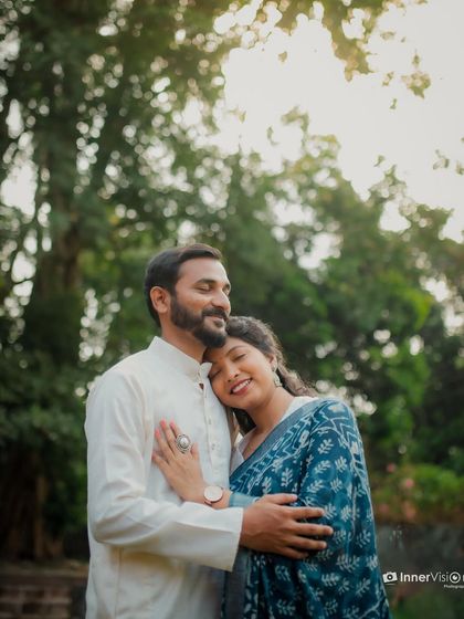 A warm and loving embrace under the soft sunlight. The bride rests her head on the groom's chest, creating a portrait filled with peace and affection.