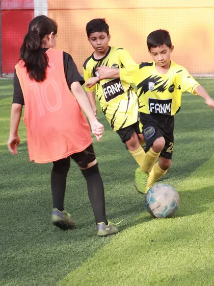 A female player challenges for the ball in a practice match, demonstrating her competitive spirit.