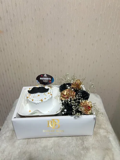 A stylish Father's Day hamper with a mustache-themed bento cake and a bouquet of black and gold faux flowers.
