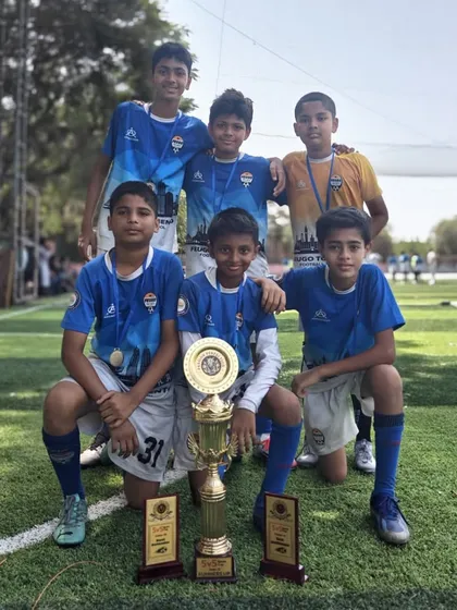 Another one of our winning youth teams celebrating their victory with their trophies.