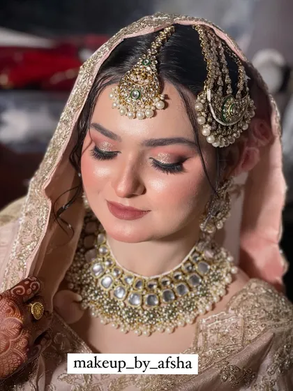 The dupatta setting is crucial for a Nikkah look. Here it is perfectly placed over her head.