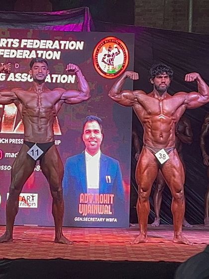 A front double biceps pose on the Mr. Asia stage. Notice the muscle separation and symmetry, key details we perfect during contest prep.