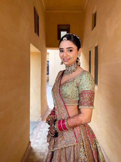 A portrait of the smiling bride. Her unique braided hairstyle is a reflection of her modern and chic personality.