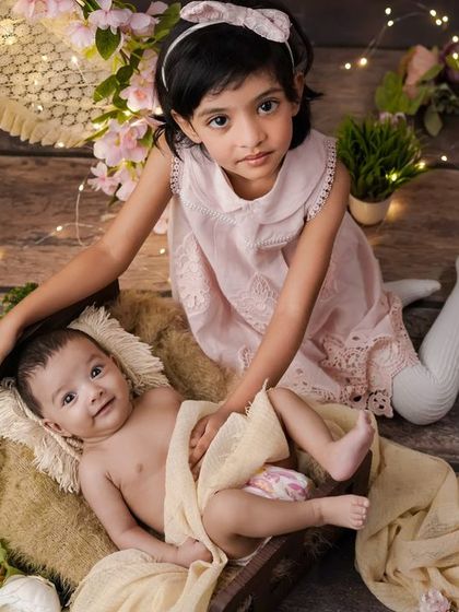 A moment of shared joy. I love seeing the happiness on a big sister's face as she gets to be part of her new sibling's first photoshoot.