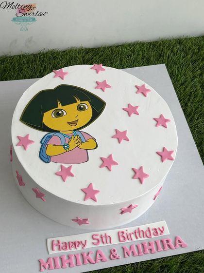 An adventurous Dora the Explorer cake for a fifth birthday. This simple design uses an edible print of Dora surrounded by fondant stars, all on a classic butterscotch cake.