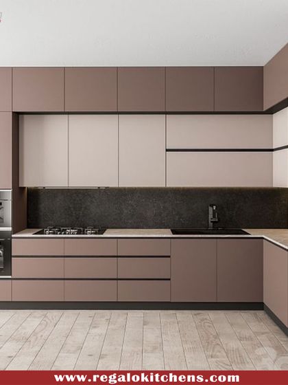 A two-tone kitchen design with brown and beige cabinets. We integrated double wall ovens and a hob into the layout for a professional-grade cooking setup. The dark backsplash provides a striking contrast.
