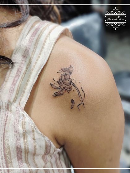 A beautiful birth flower tattoo on the shoulder. We love creating these personalized floral pieces, designing each one to be as unique as the person wearing it.