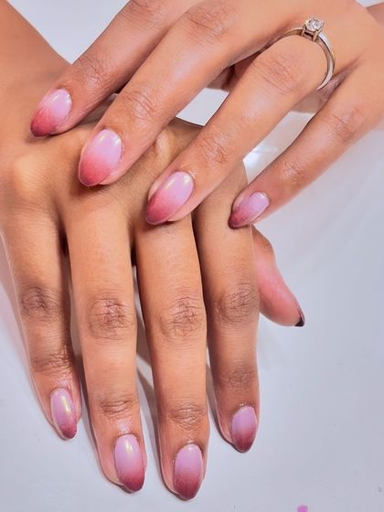 A full view of the elegant and subtle ombre chrome nails.