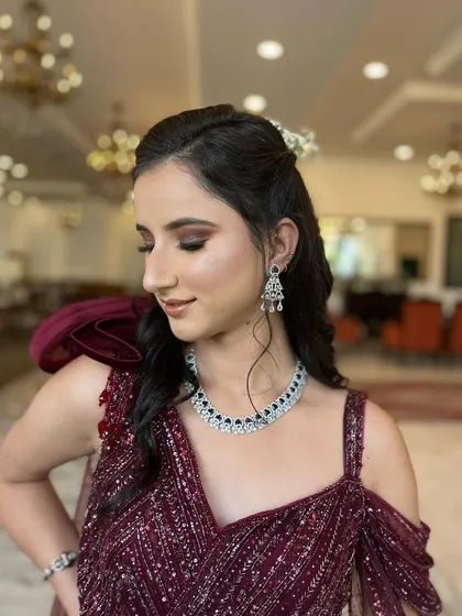 A cocktail stunner. This client is wearing a beautiful wine-colored gown, and I gave her a soft smokey eye and loose waves.