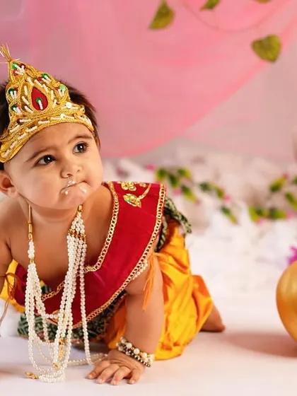 Caught with a little 'makhan' on his face! This crawling pose captures the playful spirit of Lord Krishna, adding a fun narrative to the photoshoot.