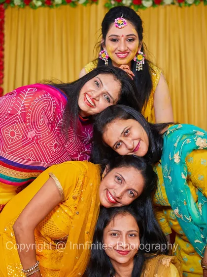 A fun group portrait of the bride and her friends during the Haldi ceremony. These photos with your closest friends are an essential part of the pre-wedding celebration.