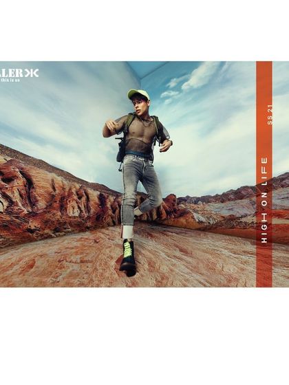 An action shot from the Killer Jeans SS21 campaign. The model is styled in lightweight, durable clothing suitable for hiking, connecting the brand's denim with an active and adventurous lifestyle.