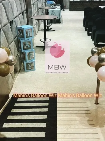 A detail shot showing the aisle decor, including "BABY" blocks and small balloon clusters that continue the theme throughout the venue.