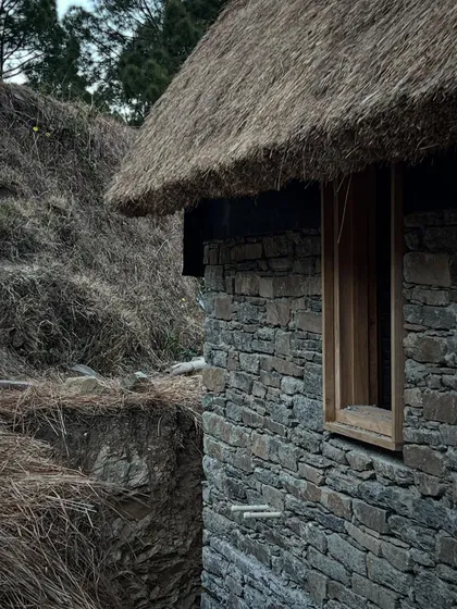 The corner of one of our stone guesthouses in the Himalayas, showing how the structure is cut into the earth. This technique helps with thermal insulation and minimizes the visual impact of the building on the natural terrain.