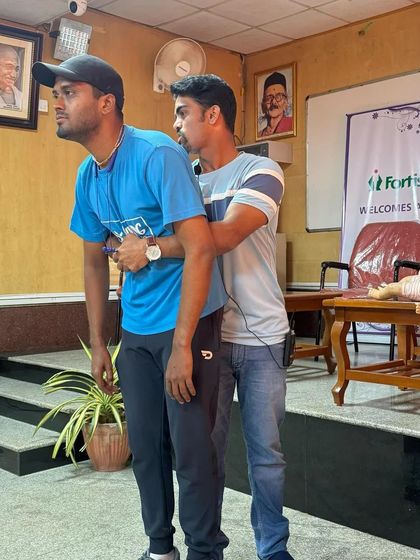 A demonstration of the Heimlich maneuver for choking emergencies. This practical training ensures our team is prepared to handle various medical situations during a race.