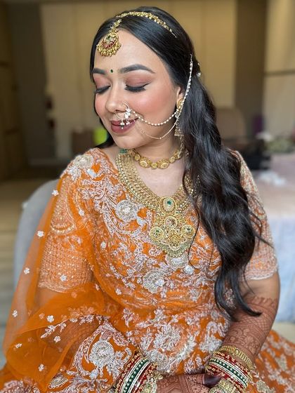 The bride looking down, showcasing her soft eye makeup and the gentle waves of her hair. This is a timeless and graceful bridal look.