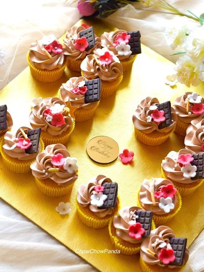 A full overhead shot of the choco-vanilla cupcakes, arranged neatly for a birthday party.