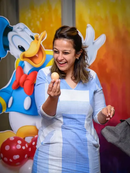 A parent volunteer is amazed by a magic trick. The adults have just as much fun as the kids!