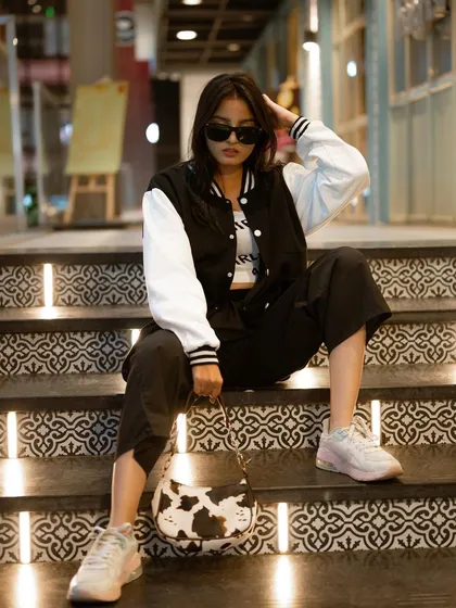 A duplicate of image 32, this cool, relaxed portrait on a set of illuminated stairs has a modern, laid-back street style vibe.