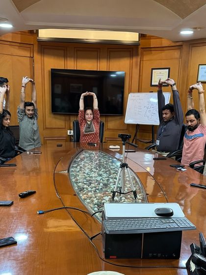 Leading a yoga session in the conference room at SMC Headquarters. It's amazing to see how a corporate space can be transformed into a place of wellness and mindfulness.