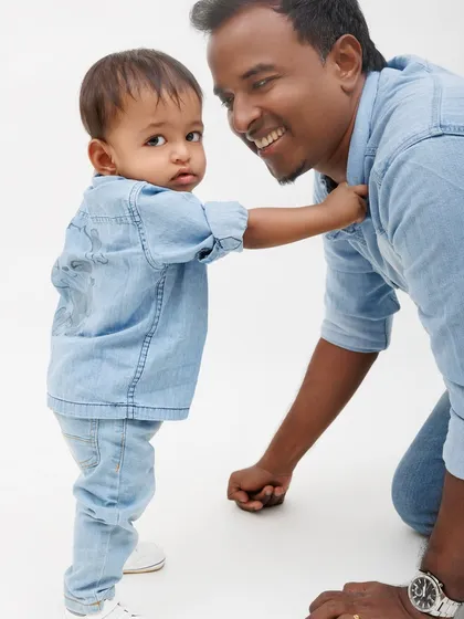 The curiosity of a child is wonderful to photograph. This candid moment between father and son shows a glimpse of their everyday interactions.