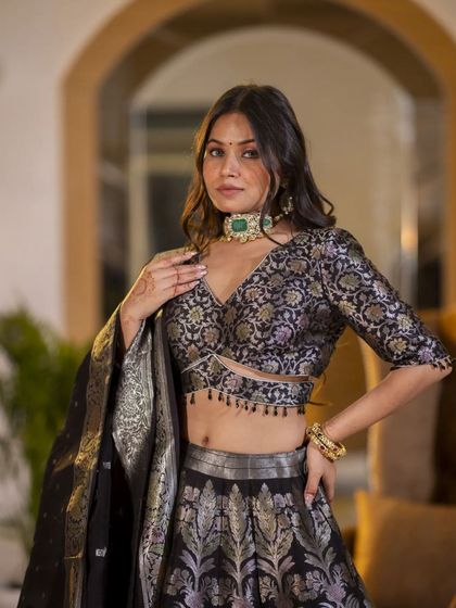 A closer shot of the Banarasi lehenga, focusing on the detailed blouse and the model's jewelry. This helps highlight how the outfit can be styled for a wedding or special occasion.