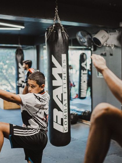 I mirror my student's movements during a Wai Kru practice session. This shows him the correct form and reinforces the deep respect we have for the traditions of Muay Thai.