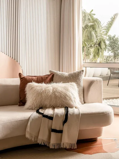 A close-up of the plush, textured fabrics used on the living room sofa, adding to the home's cozy and comfortable feel.