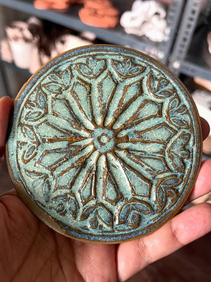 A close-up of a beautifully textured and glazed piece made by a student. The details are just lovely.