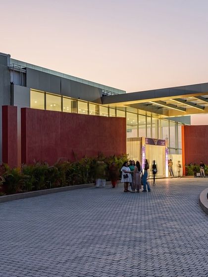The entrance to the Glass Pavilion at dusk. The warm interior lighting makes the building glow, creating an inviting and elegant atmosphere for evening events.