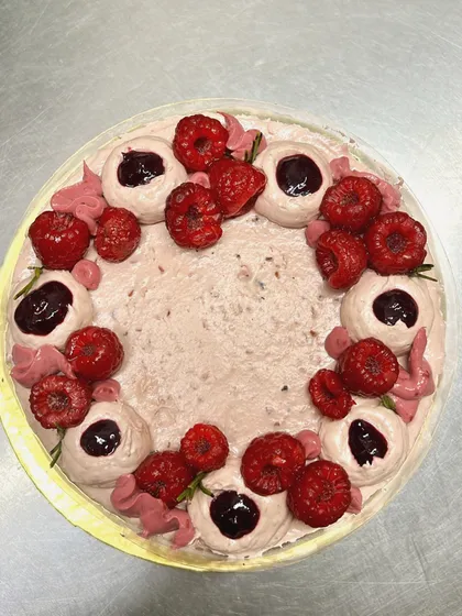 A top-down view of my Vegas Special Raspberry Heaven Cake. The combination of raspberry compote, light mousse, and fresh berries makes every bite a delight.