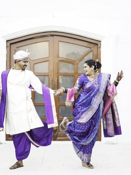 A fun and energetic dance pose, capturing the couple's joyful and playful spirit.