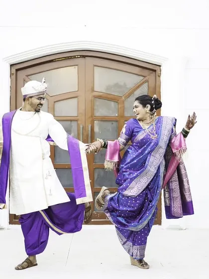 A fun and energetic dance pose, capturing the couple's joyful and playful spirit.