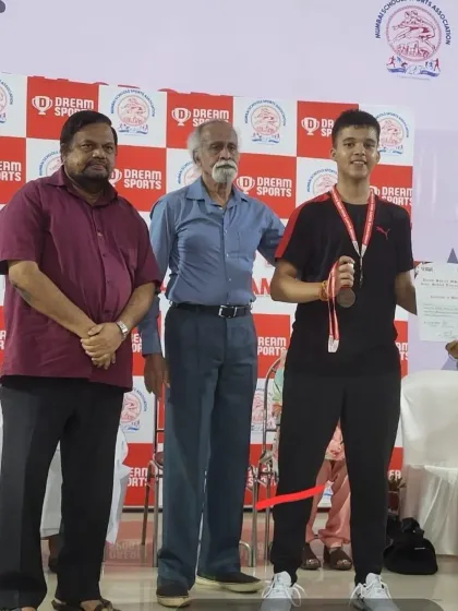 Vikrant on the podium receiving his award at the MSSA Interschool Badminton Tournament. His dedication in training is clearly visible in his performance.
