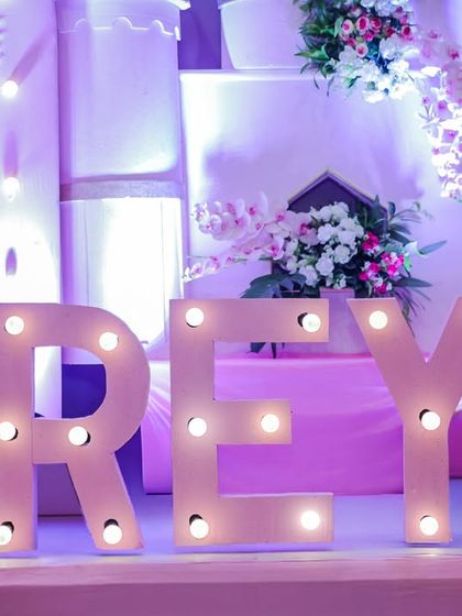 Personalized light-up marquee letters spelling out the birthday girl's name, "FREYA". This is a fantastic way to customize the decor and make the guest of honor feel extra special.