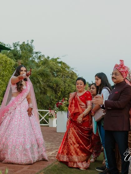 The bride's family looking on with pride and joy as she makes her way to the mandap.