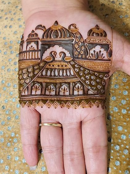 A trial piece on a different skin tone, showing how our natural henna creates a beautiful stain on everyone. The palace and peacock design is sharp and clear.