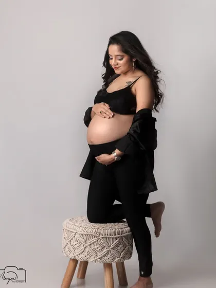 A powerful and graceful pose, highlighting the beauty of the pregnant form.