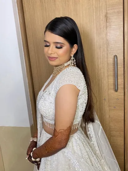 For another of Twinkle's Sangeet looks, we went with a classic smokey eye and a sleek hairstyle. She looks effortlessly chic in her white Seema Gujral design.