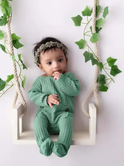 A full view of the adorable swing setup, showing the baby comfortably and safely posed. This highlights one of the many creative prop options available in my studio.